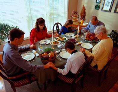 family praying around table