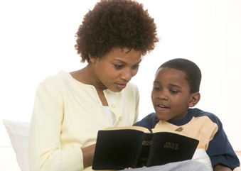 mom reading bible to child